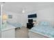 Bright bedroom featuring two twin beds, ceiling fan and a window at 4 Bunker Rd, Rotonda West, FL 33947