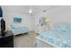 Bright bedroom features two twin beds, ceiling fan and a dresser at 4 Bunker Rd, Rotonda West, FL 33947