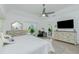 Inviting bedroom featuring a ceiling fan, pool view, and neutral decor at 4 Bunker Rd, Rotonda West, FL 33947