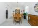Dining room features a classic wooden table, six chairs and ample natural light at 4 Bunker Rd, Rotonda West, FL 33947