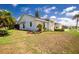 Home exterior features a well manicured lawn with mature trees and fresh mulch at 4 Bunker Rd, Rotonda West, FL 33947