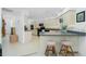 A kitchen featuring light cabinets, a breakfast bar, and tile flooring at 4 Bunker Rd, Rotonda West, FL 33947