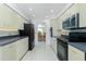 Modern kitchen with black appliances and view to the dining room at 4 Bunker Rd, Rotonda West, FL 33947