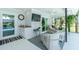 Enclosed lanai provides a serene escape with lounge chairs, a ceiling fan, and a view of the sparkling pool at 4 Bunker Rd, Rotonda West, FL 33947