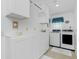 Bright laundry room with white cabinetry, washer, and dryer at 4 Bunker Rd, Rotonda West, FL 33947