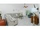 Bright living room with large sectional, modern ceiling fan, and sliding door at 4 Bunker Rd, Rotonda West, FL 33947