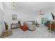 Open living room with a plush sectional sofa, ceiling fan and view of pool area at 4 Bunker Rd, Rotonda West, FL 33947