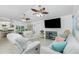 Open-concept living room with tile flooring, comfortable seating, and a view into the dining area and kitchen at 4 Bunker Rd, Rotonda West, FL 33947