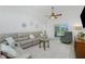 Comfortable living room featuring a sectional sofa, glass table, and sliding glass doors at 4 Bunker Rd, Rotonda West, FL 33947
