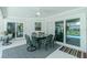 Outdoor dining set on covered patio, leading to the outdoor pool area at 4 Bunker Rd, Rotonda West, FL 33947