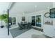 Covered patio with outdoor dining area and access to outdoor kitchen at 4 Bunker Rd, Rotonda West, FL 33947