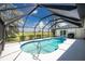 Sparkling pool featuring a screened enclosure and sunny blue skies above at 4 Bunker Rd, Rotonda West, FL 33947
