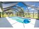 Enclosed pool with blue water, and outdoor seating offers a private oasis in the Florida sunshine at 4 Bunker Rd, Rotonda West, FL 33947