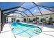 Gorgeous pool with sun shelf, steps, and a screened-in enclosure at 4 Bunker Rd, Rotonda West, FL 33947
