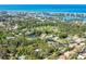 Aerial view of a charming home nestled among trees, offering a peaceful atmosphere with ocean views at 425 Laurel W Rd, Nokomis, FL 34275