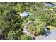 Aerial view of the home showcasing its secluded setting with lush greenery and mature trees at 425 Laurel W Rd, Nokomis, FL 34275