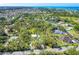 Expansive aerial view outlining the property, showing a private residence amidst lush green trees at 425 Laurel W Rd, Nokomis, FL 34275