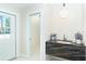 Stylish bar area with a marble countertop, coffee machine, and ample cabinet space at 425 Laurel W Rd, Nokomis, FL 34275