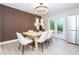Dining room featuring modern light fixture, decorative wall panel and an adjoining refrigerator at 425 Laurel W Rd, Nokomis, FL 34275