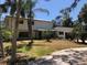 Home exterior with lush trees, and front lawn at 425 Laurel W Rd, Nokomis, FL 34275