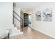 Bright foyer with a modern staircase, wood floors, and contemporary artwork at 425 Laurel W Rd, Nokomis, FL 34275