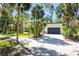 Contemporary home showcasing lush landscaping, a driveway, and ample parking in a scenic location at 425 Laurel W Rd, Nokomis, FL 34275