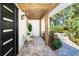 Cozy front porch with seating surrounded by beautiful landscaping, offering a welcoming entrance at 425 Laurel W Rd, Nokomis, FL 34275
