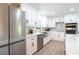 Modern kitchen with white cabinets, stainless steel appliances, and a farmhouse sink at 425 Laurel W Rd, Nokomis, FL 34275
