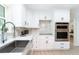 Bright kitchen with stainless steel appliances, white cabinets, and modern design at 425 Laurel W Rd, Nokomis, FL 34275