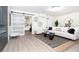 Open-concept living room with a cozy seating area, stylish decor, and a sliding barn door to the bedroom at 425 Laurel W Rd, Nokomis, FL 34275