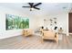 Bright living room featuring modern furnishings, natural light, and wood laminate floors at 425 Laurel W Rd, Nokomis, FL 34275
