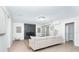 Spacious living room with modern fireplace, neutral tones, and a sliding barn door to the main bedroom at 425 Laurel W Rd, Nokomis, FL 34275