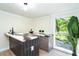 Chic wet bar area featuring modern countertops and a view of the well-maintained outdoors at 425 Laurel W Rd, Nokomis, FL 34275
