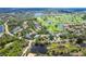 Stunning aerial view of neighborhood featuring golf course and pond views at 5 Saint John Blvd, Englewood, FL 34223