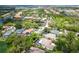 Aerial view of a home with a private pool surrounded by lush landscaping at 5 Saint John Blvd, Englewood, FL 34223