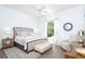 Bright bedroom with a comfortable bed, neutral color scheme and beautiful outdoor view at 5 Saint John Blvd, Englewood, FL 34223