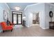 Bright entryway with double doors, light blue walls, and a glimpse into an adjacent living space at 5 Saint John Blvd, Englewood, FL 34223