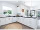 Bright kitchen with white cabinets, dark countertops, stainless steel appliances, and natural light at 5 Saint John Blvd, Englewood, FL 34223