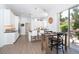 Bright kitchen features white cabinetry, modern appliances, and a breakfast table with seating at 5 Saint John Blvd, Englewood, FL 34223