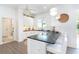 This kitchen offers white cabinets, a dark counter top, stainless steel appliances, and pendant lighting at 5 Saint John Blvd, Englewood, FL 34223