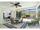 Enjoy this cozy outdoor living space with comfortable seating and views of the lush landscaping at 5 Saint John Blvd, Englewood, FL 34223