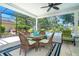 Charming outdoor dining area on the screened lanai, perfect for enjoying meals by the pool at 5 Saint John Blvd, Englewood, FL 34223