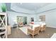 Spacious living room with ample seating, sliding glass doors to lanai, and a decorative tray ceiling at 5 Saint John Blvd, Englewood, FL 34223