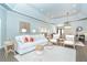 Bright and airy living room features modern decor, a white sofa, and a cozy seating area at 5 Saint John Blvd, Englewood, FL 34223