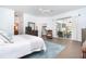 Bright main bedroom featuring a king-size bed, a ceiling fan, and access to the outdoors at 5 Saint John Blvd, Englewood, FL 34223