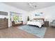 Serene main bedroom featuring natural light, a seating area, and calming decor at 5 Saint John Blvd, Englewood, FL 34223