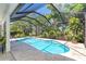 Inviting screened pool with sunny views and lush landscaping offers a private outdoor oasis at 5 Saint John Blvd, Englewood, FL 34223