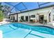 Enjoy Florida living with a screened-in pool and outdoor seating areas at 5 Saint John Blvd, Englewood, FL 34223