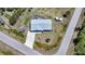 Aerial view of a home with a driveway, boat, and deck surrounded by lush greenery at 5460 Norlander Dr, Port Charlotte, FL 33981