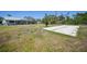 Expansive backyard with a bocce ball court, screened patio, and ample green space at 5460 Norlander Dr, Port Charlotte, FL 33981
